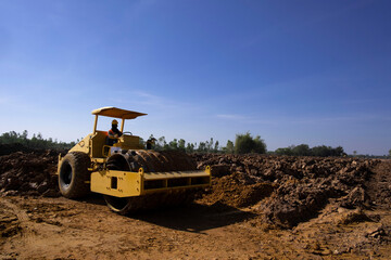 Soil compactor padfoot drum is working. Road roller during highway building