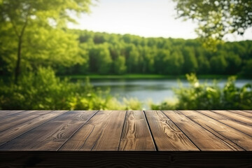 The empty wooden table top with blur background of summer lakes green forest.