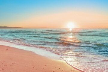 Colorful sunset viewed from the pink sea beach with soft waves - obrazy, fototapety, plakaty