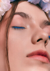 a close-up photo of an eye with blue mascara on the eyelashes  © Angelina Zhuravleva 