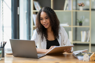 Black woman working through online meeting with team. Remote work and communication.