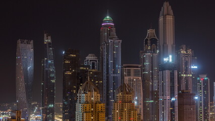 Fototapeta na wymiar Skyscrapers of Dubai Marina near Sheikh Zayed Road with highest residential buildings all night timelapse