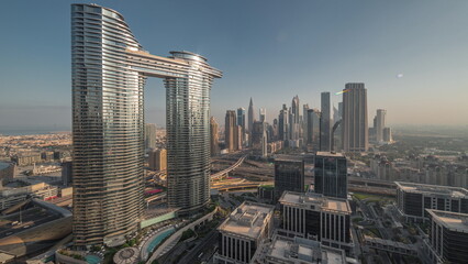Fototapeta premium Futuristic Dubai Downtown and financial district skyline aerial night to day timelapse.