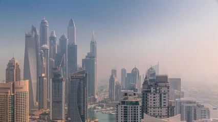 Foto op Canvas View of various skyscrapers in tallest residential block in Dubai Marina aerial timelapse © neiezhmakov
