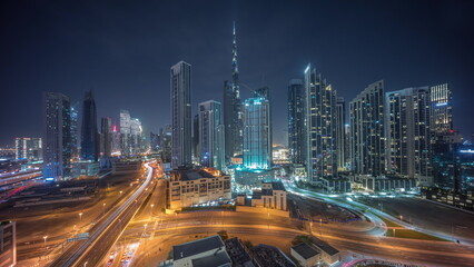 Fototapeta na wymiar Aerial panoramic view of Dubai Downtown skyline with many towers all night timelapse.