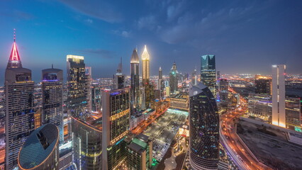 Skyline view of the high-rise buildings on Sheikh Zayed Road in Dubai aerial day to night...