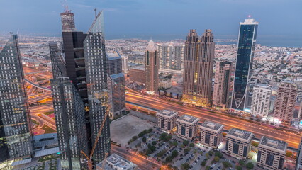 Fototapeta na wymiar High-rise buildings on Sheikh Zayed Road in Dubai aerial night to day timelapse, UAE.