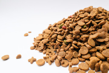 Dry cat food on a grey background.