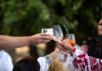 Couple clinking glass of white wine for celebration