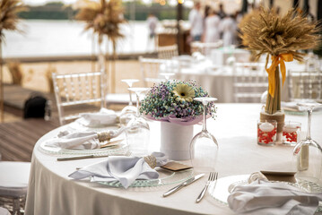 Wedding table setting decorated with flowers and dishes