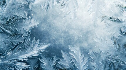 A frame of a frosty pattern of ice crystals on a blurred winter background. A frame with an abstract ice structure allows you to apply or add a frost effect. Frost on the glass, freezing effect