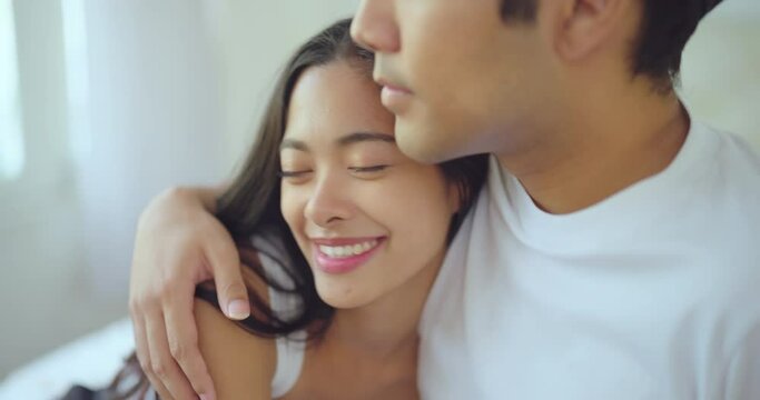 Happiness moment, Young asian couple with happy expression in bedroom at home. They enjoying together with this moment.