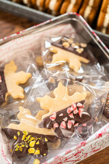 Obraz na płótnie Canvas Festive Christmas Tin Boxes Filled with Chocolate-Dipped Treats