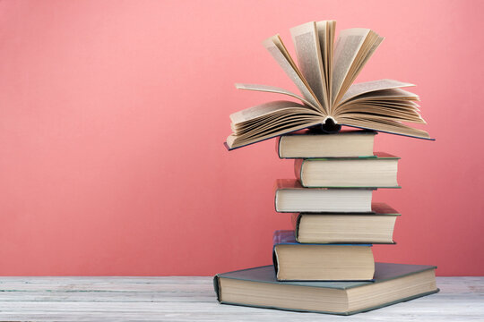 Stack of colorful books. Education background. Back to school. Book, hardback colorful books on wooden table. Education business concept. Copy space for text.