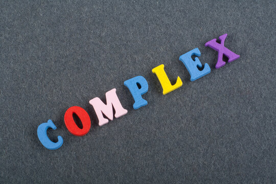 COMPLEX word on black board background composed from colorful abc alphabet block wooden letters, copy space for ad text. Learning english concept.