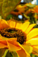 Close-up of artificial sunflower in the outdoors with sunlight. Artificial sunflower for decoration.