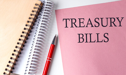 TREASURY BILLS word on the pink paper with office tools on white background
