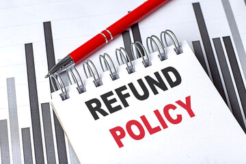 REFUND POLICY text written on notebook with pen on chart