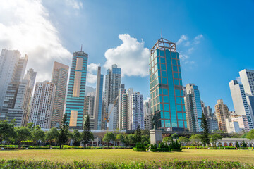 Wide view Hong Kong of skyscrapers and residential area square in city park with monument Sun Yat Sen Statue. - obrazy, fototapety, plakaty