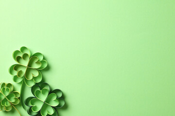 Four-leaf clover on green background for St Patricks Day. Paper art and craft style.