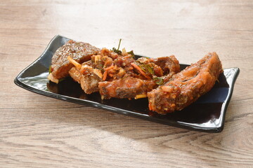 deep fried slice mango fish with tomato and chili in sweet sour sauce on plate 