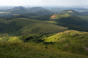 Obraz premium Auvergne vulcan since top of the Puy de Dome vulcan at sunset. Dramatic light landscape. Clermont Ferrand, France.