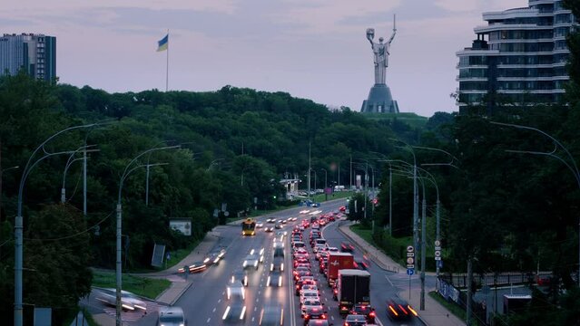 Kyiv city time laps with many cars and buses on speed during the sunset