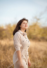 Beautiful young romantic woman on autumn walk, dreamy girl on nature