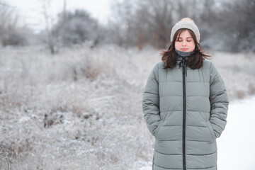 young beautiful woman walking on winter nature, pretty brunette girl with closed eyes relaxing