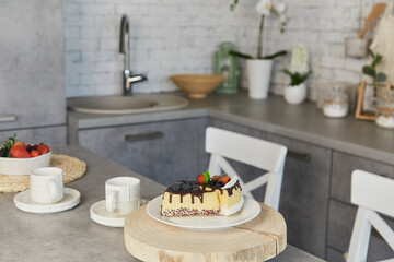 Contemporary kitchen scene featuring dessert and coffee for two. Artificial food