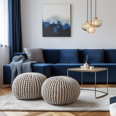 Two knitted poufs near a dark blue corner sofa. Scandinavian home interior design of a modern living room