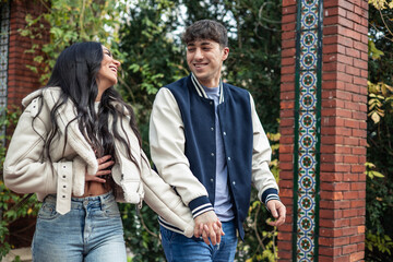 young latin couple laughing in love on their first date