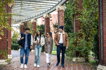 group of four university friends returning from class