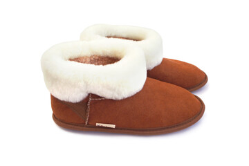 Brown ugg boots with fur isolated on white background. Home slippers with white sheep's wool. Side view.
