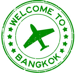 Grunge green welcome to bangkok with airplane icon round rubber seal stamp on white background