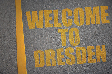 asphalt road with text welcome to Dresden near yellow line.