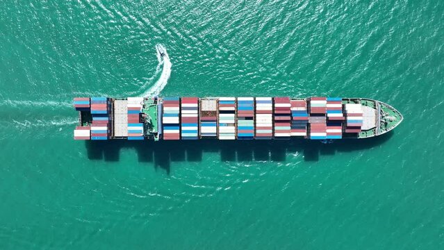 Aerial view of Cargo Container Ship at sunrise. container ship running out of cargo shipyard sea port. export shipping industry freight and transportation logistics concept. commercial shipping by sea