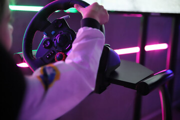 Child's hand on the steering wheel party amusement rides vulvaroofiofly in white suit computer...