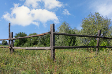 wooden fence on meadow - 719075811