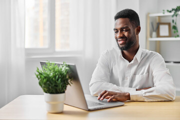 freelancer man computer american office education african laptop online indoor student job