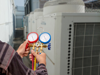 Air conditioner technician checking air conditioner operation
