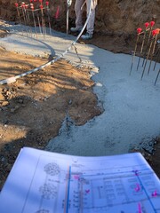 Doing the foundations in a construction site looking the floor plans. Checking the construction...