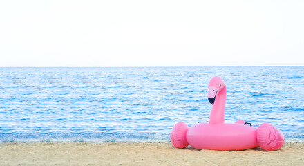 Inflatable circle lies on the seashore. Summer vacation concept, copy space