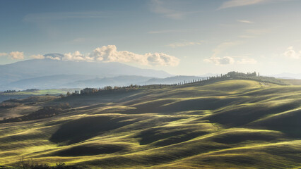 Landscape in Tuscany with farmhouse and rolling hills on a winter afternoon