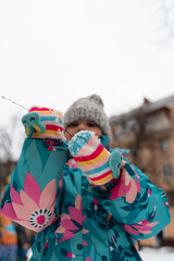 Child girl playing in snow playground in winter, 5-6 years old kid