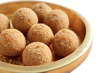Sesame caramel laddu on white background