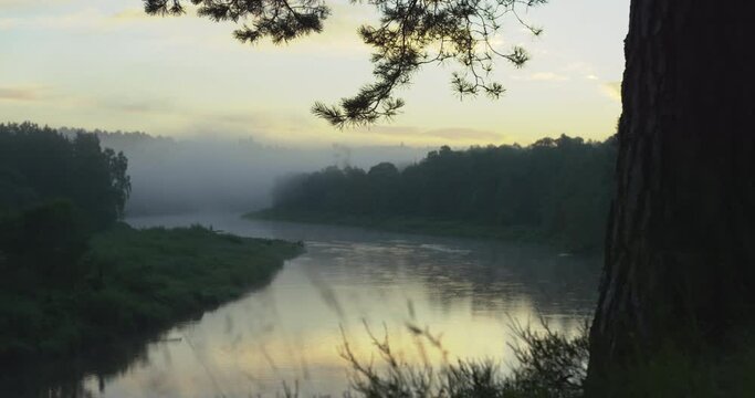 Reveal of a big river bend at dusk. Tracking shot.