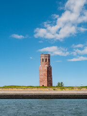 Former church tower Plompetoren on dike at Oosterschelde, Easter Scheldt, estuary, Zeeland, Netherlands