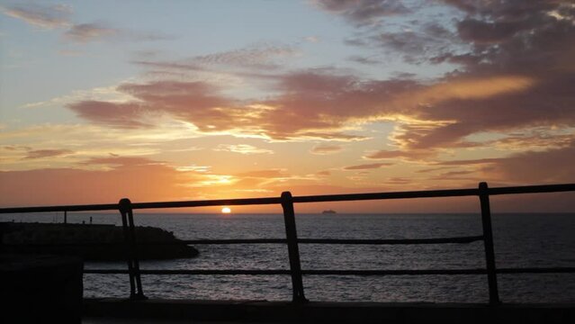 Sunset from the promenade of La Pinta beach, Tenerife south, Spain