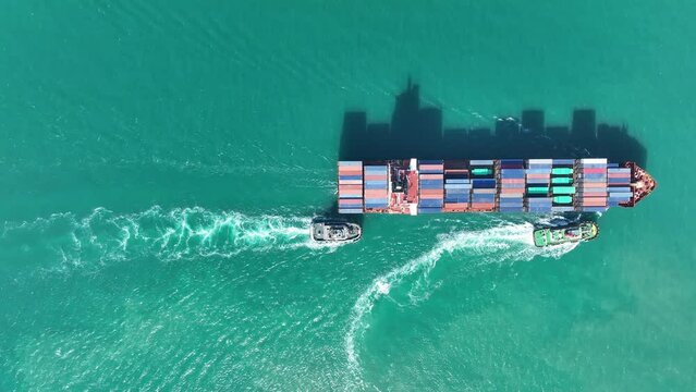 Aerial view of Cargo Container Ship at sunrise. container ship running out of cargo shipyard sea port. export shipping industry freight and transportation logistics concept. commercial shipping by sea